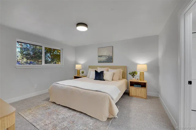 a bedroom with a bed and a night stand