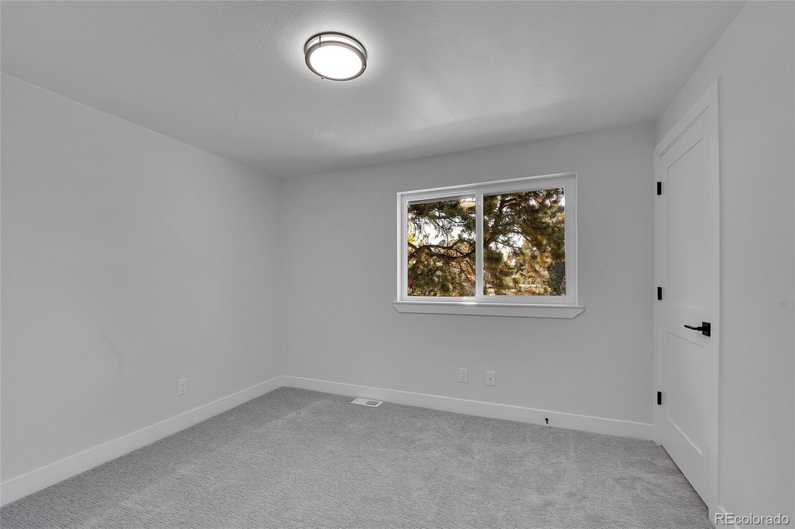3261 South Oneida Way Denver, CO 80224 - Photo 25 of 43 an empty room with a window