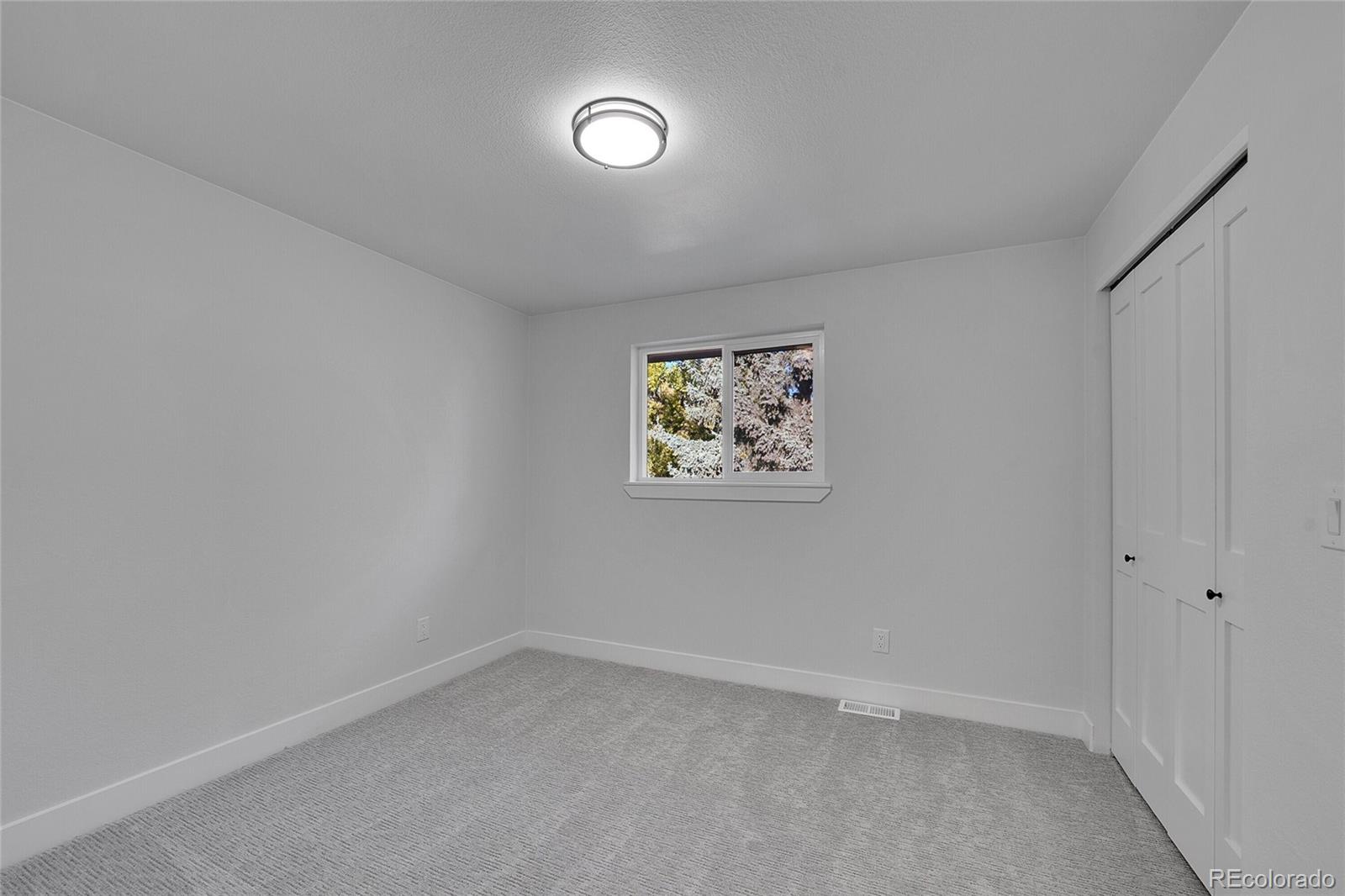 3261 South Oneida Way Denver, CO 80224 - Photo 26 of 43 an empty room with a window