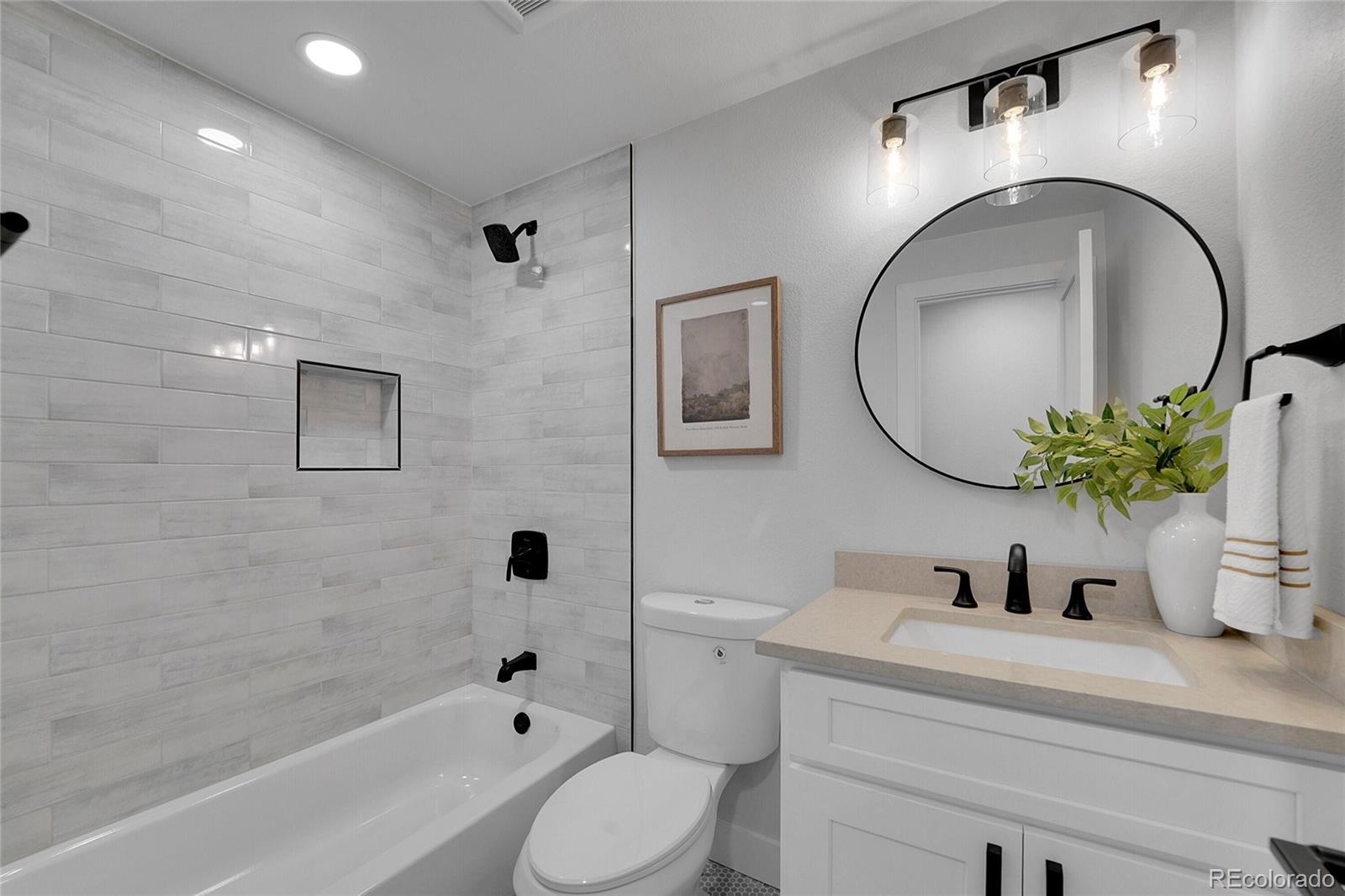 3261 South Oneida Way Denver, CO 80224 - Photo 27 of 43 a bathroom with a sink a toilet and a mirror