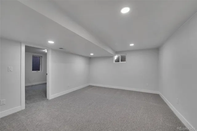 an empty room with a empty space and windows