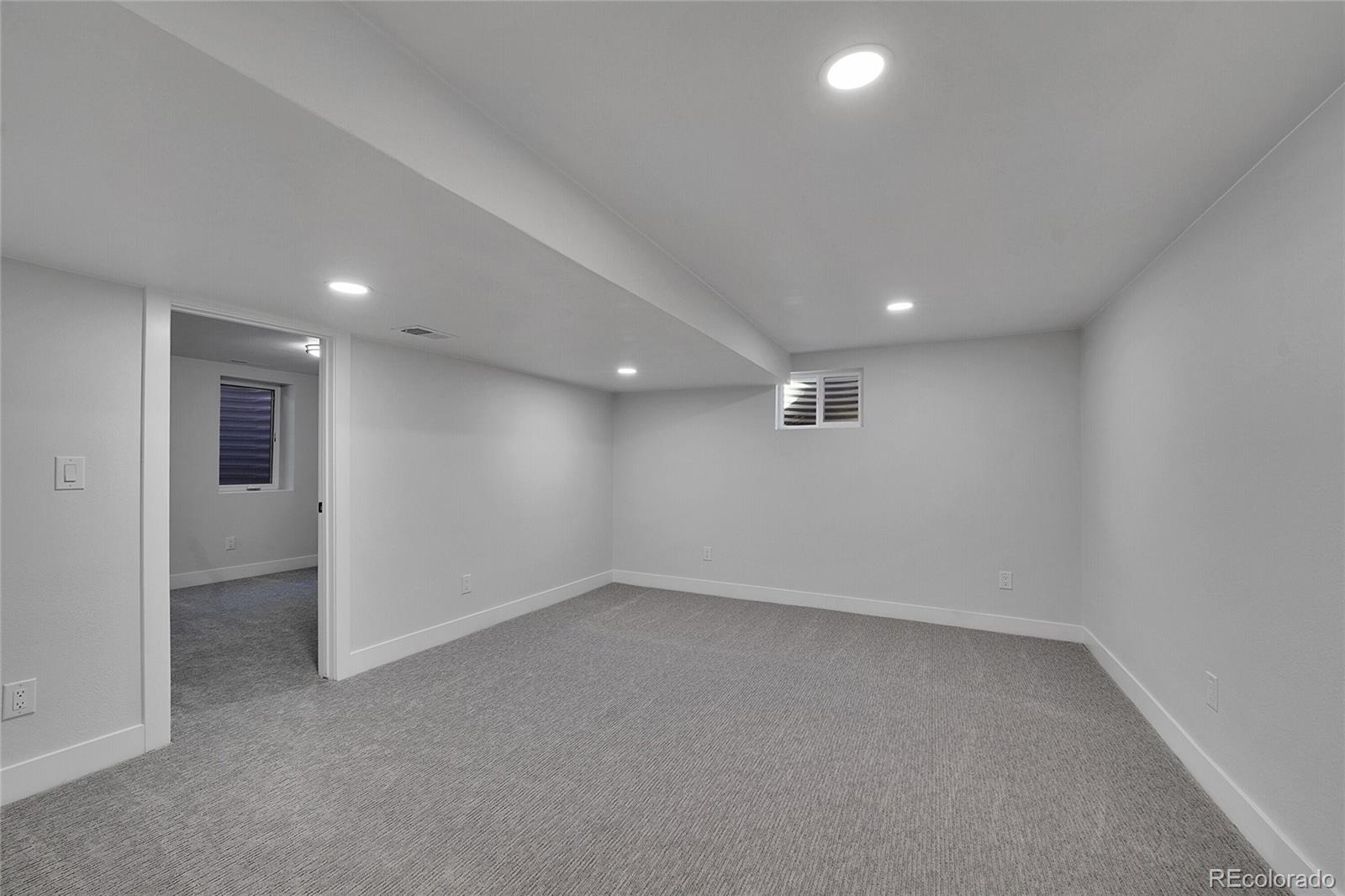 3261 South Oneida Way Denver, CO 80224 - Photo 29 of 43 an empty room with a empty space and windows