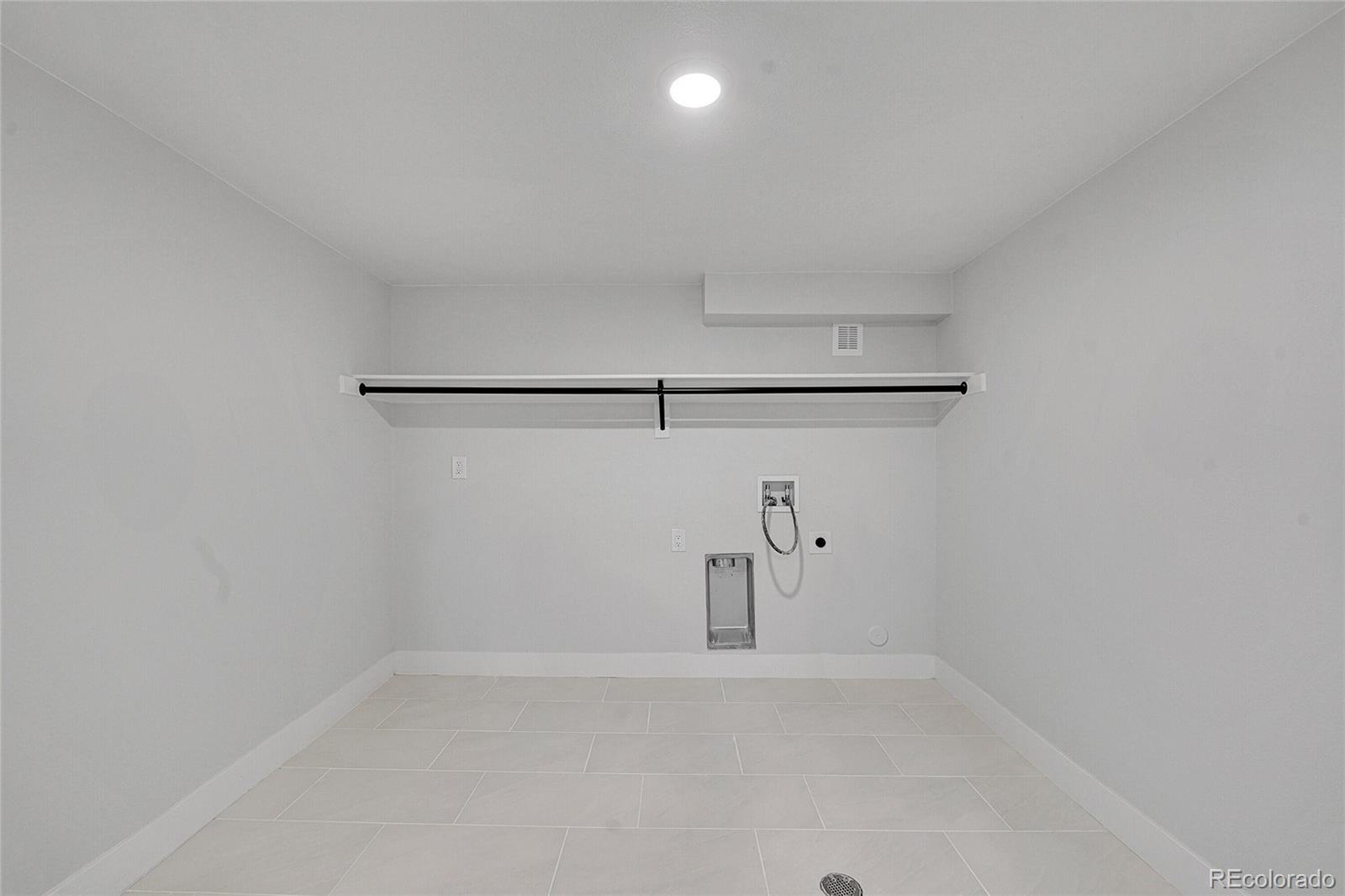 3261 South Oneida Way Denver, CO 80224 - Photo 32 of 43 a view of a refrigerator in kitchen