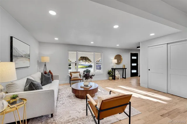 a living room with furniture and wooden floor