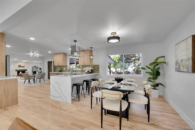 a view of a dining room kitchen with furniture and a chandelier