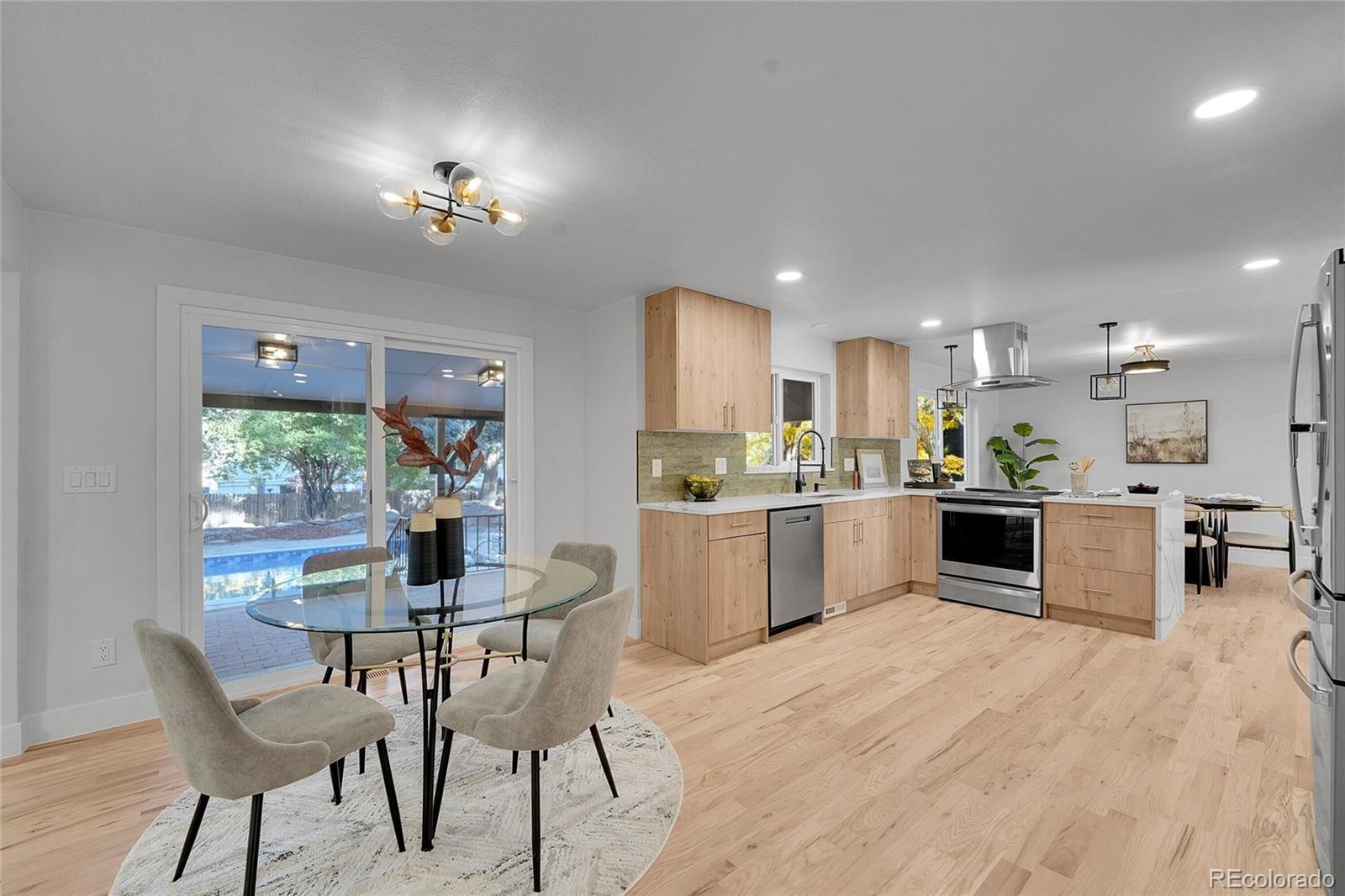 3261 South Oneida Way Denver, CO 80224 - Photo 9 of 43 a kitchen with a table and chairs in it