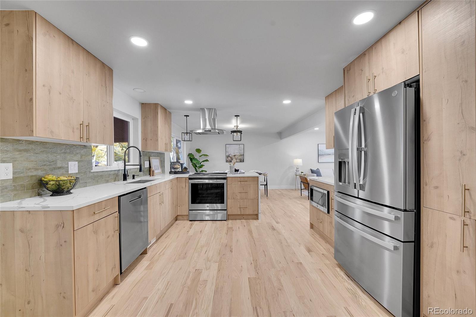 3261 South Oneida Way Denver, CO 80224 - Photo 10 of 43 a kitchen with stainless steel appliances a refrigerator sink and microwave