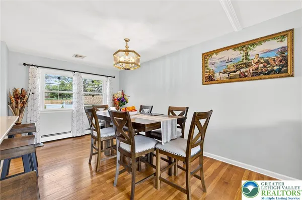 a view of a dining room with furniture window and wooden floor