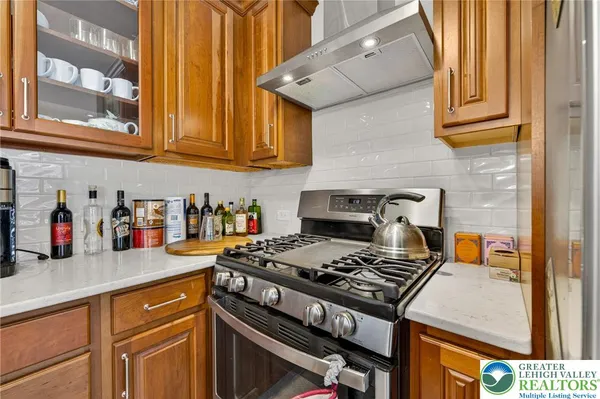 a kitchen with stainless steel appliances granite countertop a stove and a sink