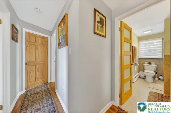 a view of an entryway with wooden floor and a bedroom