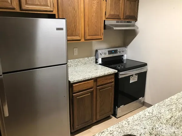 a kitchen with a refrigerator and a sink