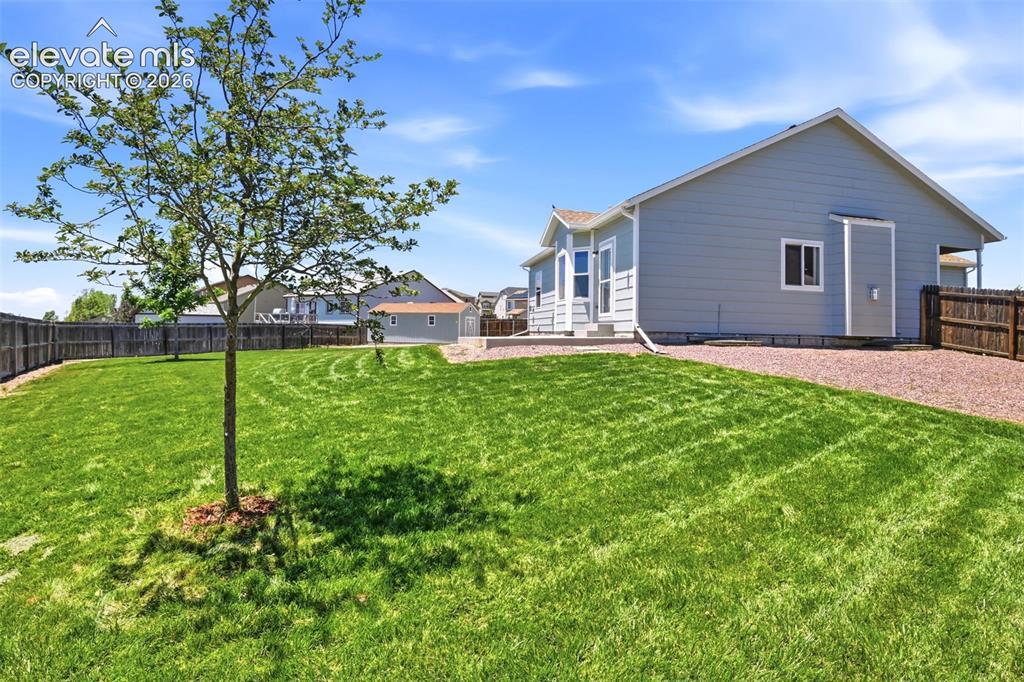 7806 Dutch Loop Colorado Springs, CO 80925 - Photo 35 of 41 a view of a house with a yard and sitting area
