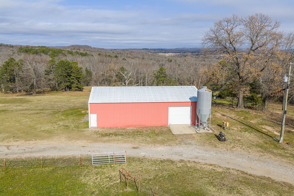 3022 Dow Jones Road Alma, AR 72921 - Photo 22 of 34 View of pole building with a yard, a wooded view, and a view of rural / pastoral area