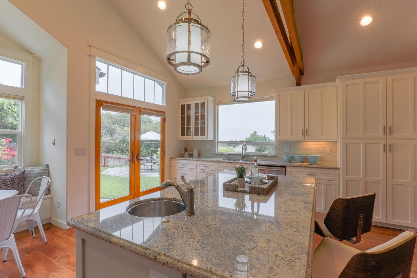 3030 Haas Drive Aptos, CA 95003 - Photo 15 of 44 a kitchen with granite countertop sink table and chairs