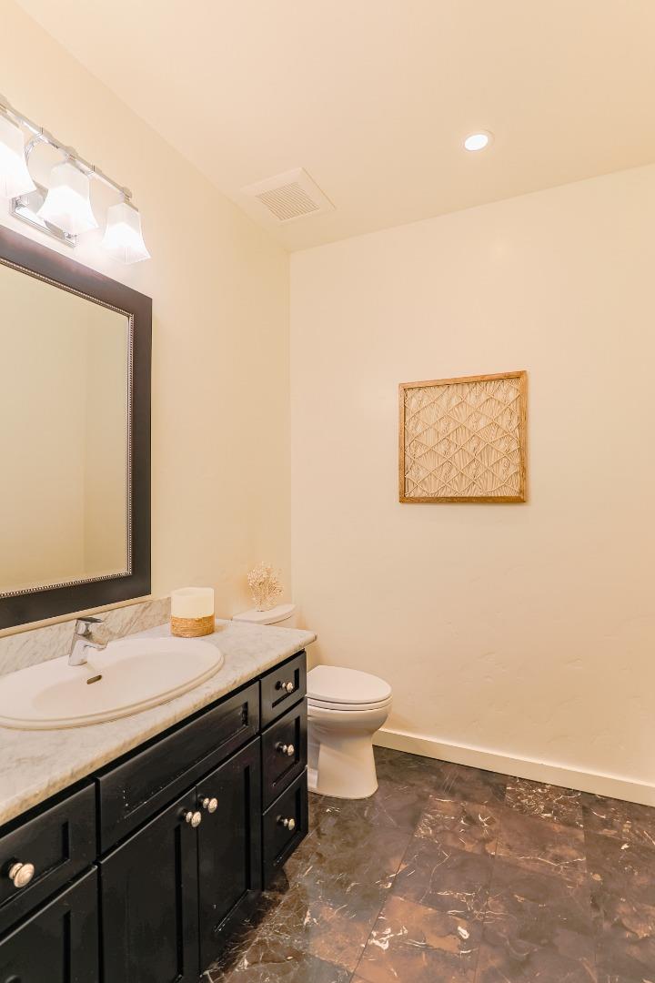 3030 Haas Drive Aptos, CA 95003 - Photo 20 of 44 a bathroom with a toilet sink and mirror