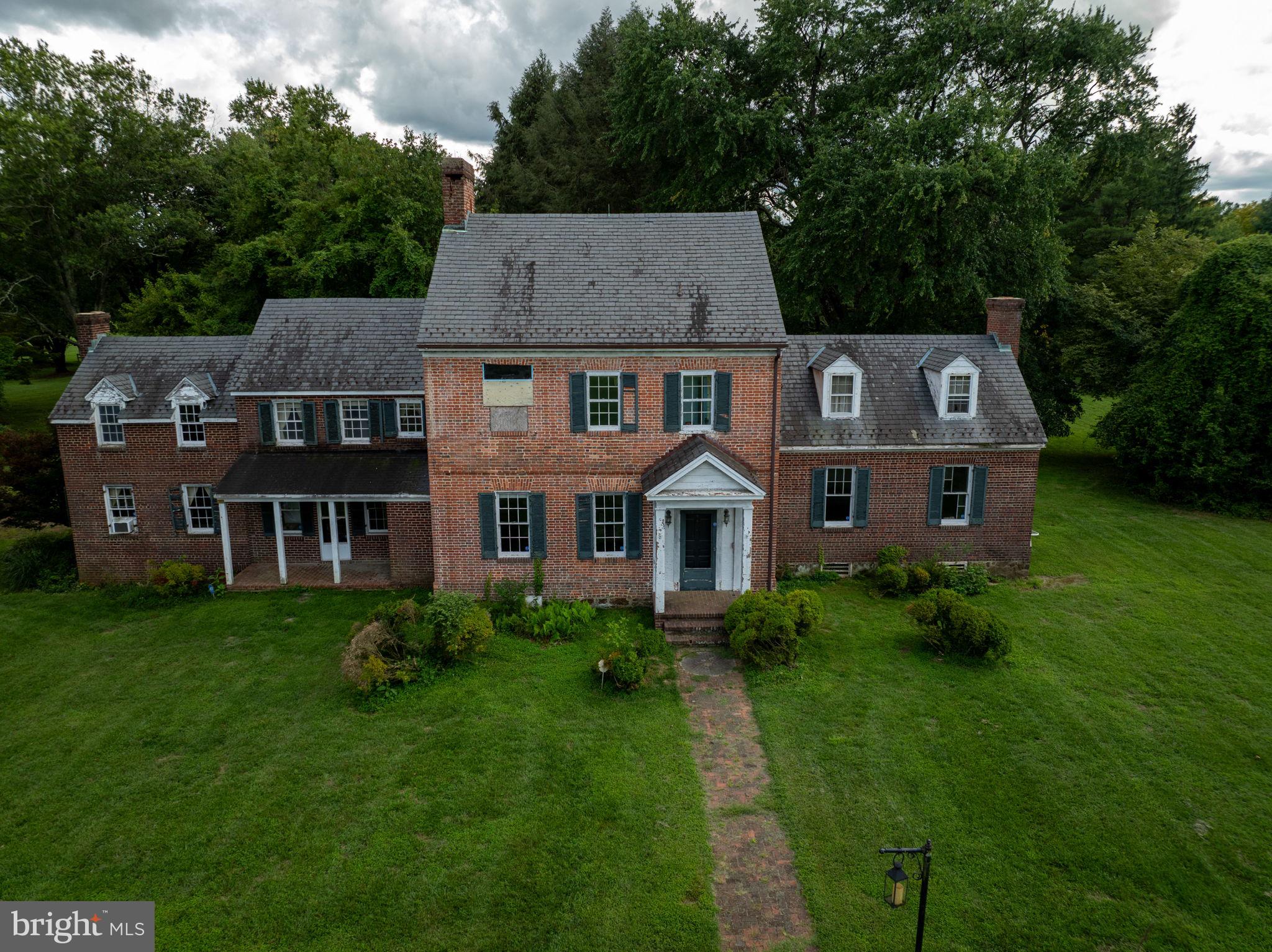 2173 Johns Hopkins Road Gambrills, MD 21054 - Photo 2 of 18 a front view of a house with a garden