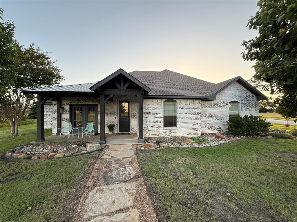1177 Lone Star Road Celina, TX 75009 - Photo 4 of 28 a front view of a house with a garden and porch