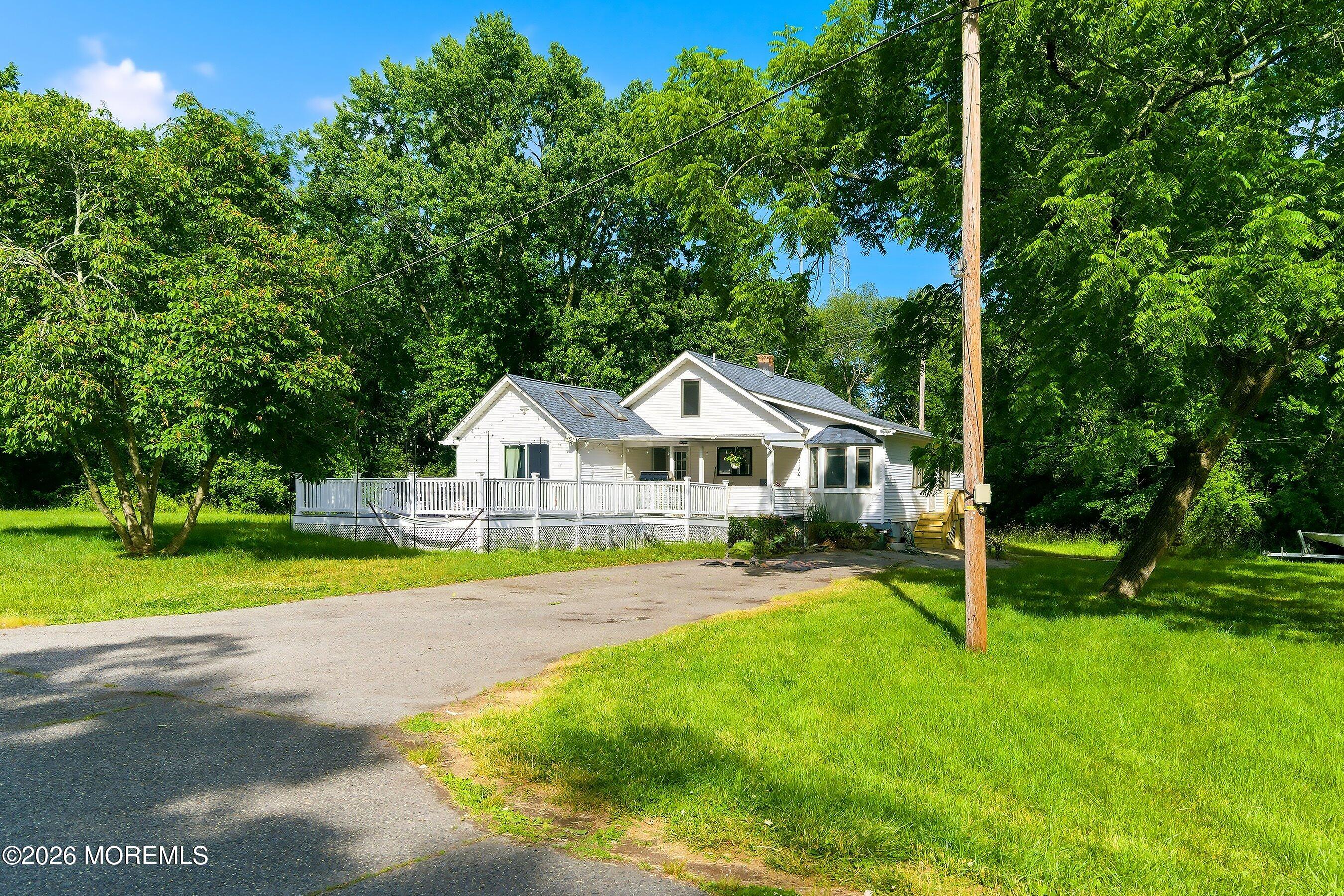 26 Megill Road Farmingdale, NJ 07727 - Photo 7 of 16 a front view of a house with a yard and green space