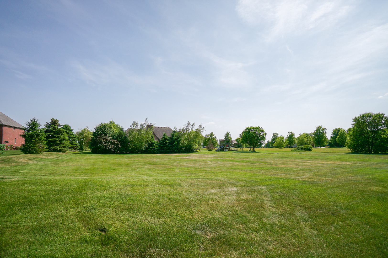 12604 Old Farm Road Manhattan, IL 60442 - Photo 4 of 24 a view of a field with trees in the background