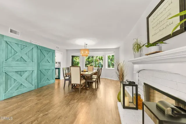 a kitchen with stainless steel appliances kitchen island granite countertop a sink and a refrigerator