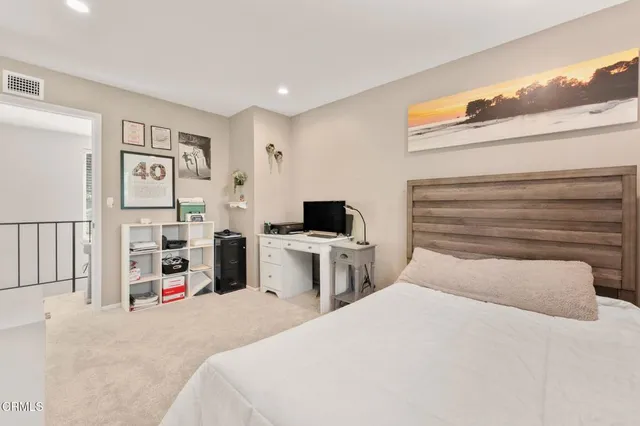 a spacious bedroom with a bed and a couch