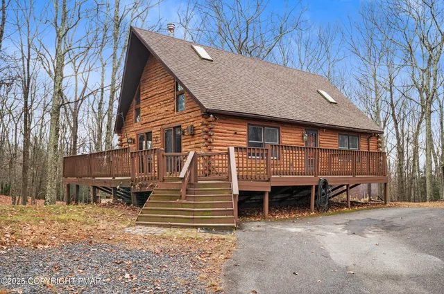 a view of a house with backyard and wooden fence