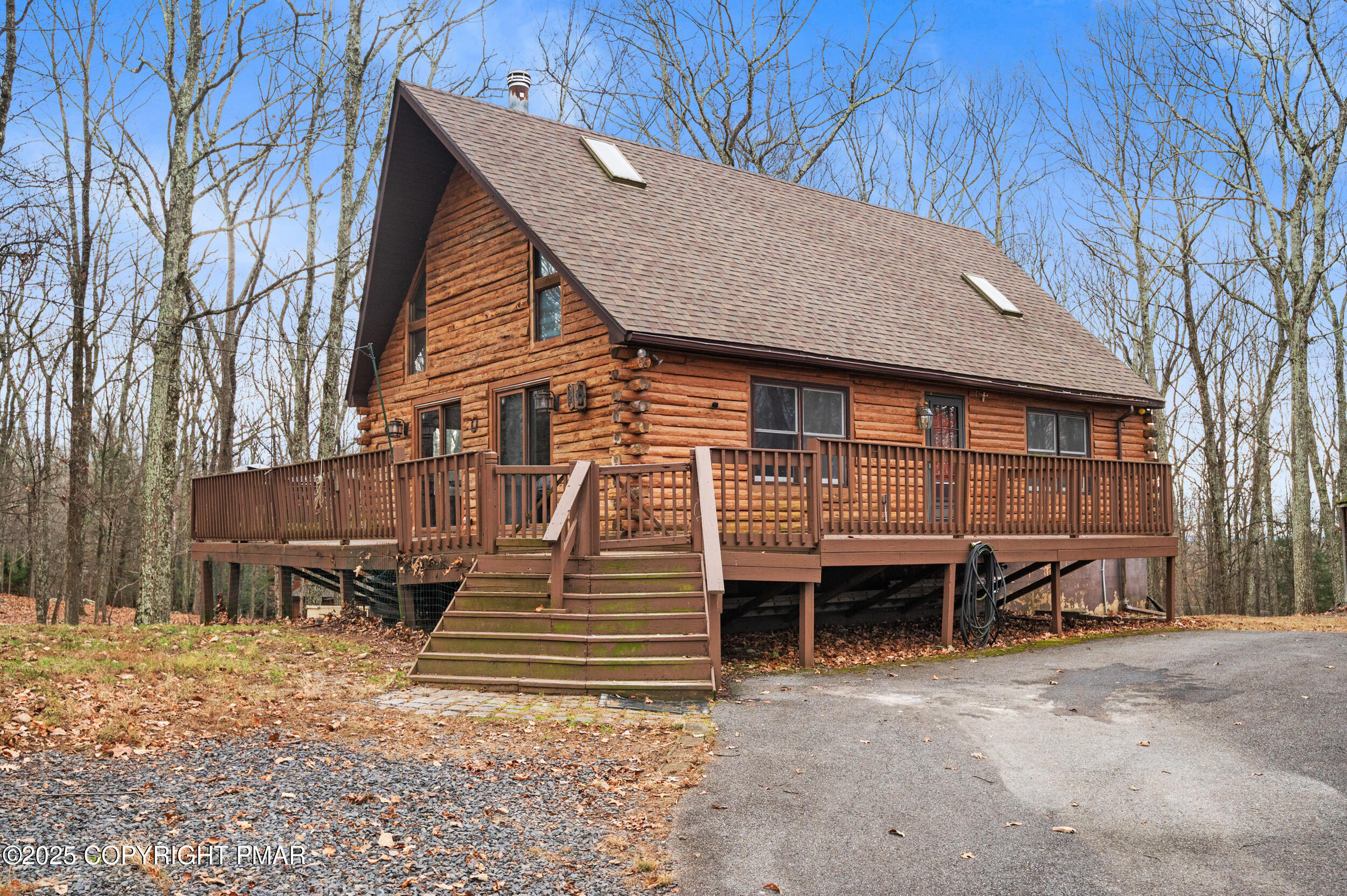 a view of a house with backyard and wooden fence