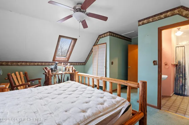 a bedroom with a bed next to a window