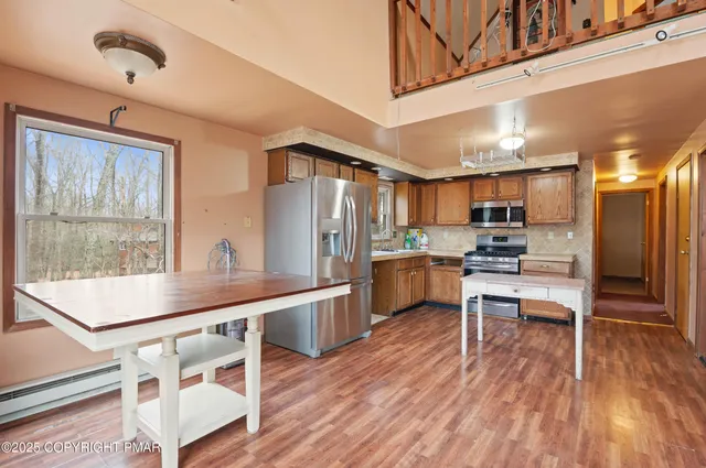 a kitchen with a table chairs refrigerator and cabinets