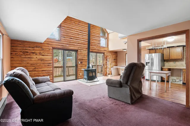 a living room with furniture and floor to ceiling windows