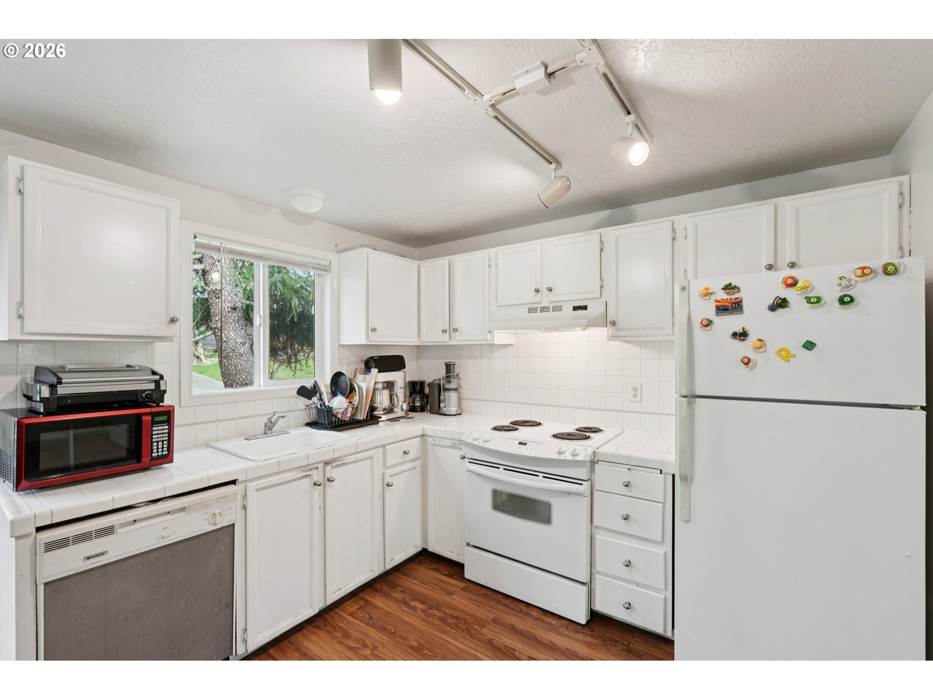 29480 Southwest Volley Street Wilsonville, OR 97070 - Photo 11 of 29 a kitchen with white cabinets and white appliances