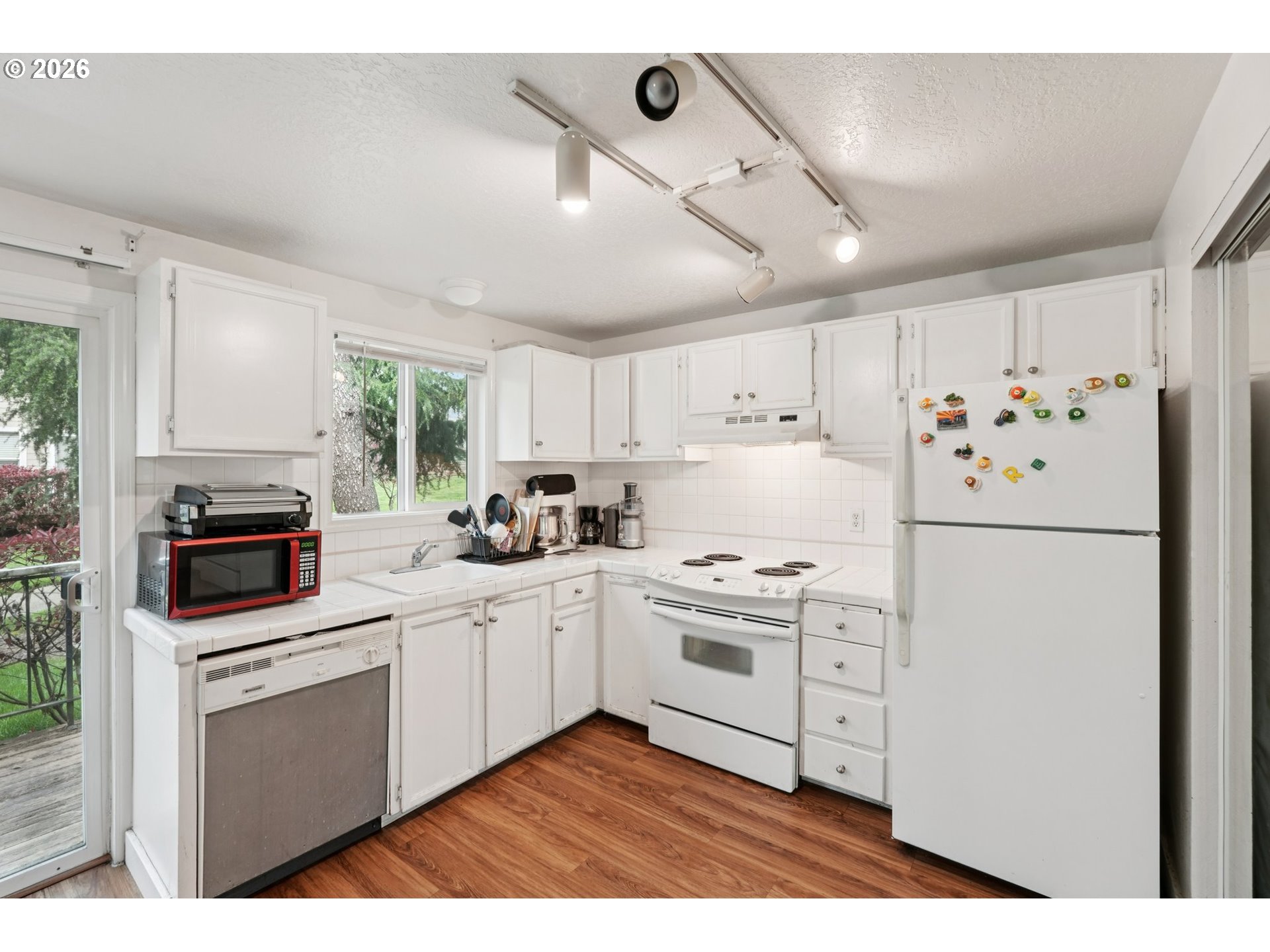 29480 Southwest Volley Street Wilsonville, OR 97070 - Photo 12 of 29 a kitchen with stainless steel appliances a stove a sink and a refrigerator