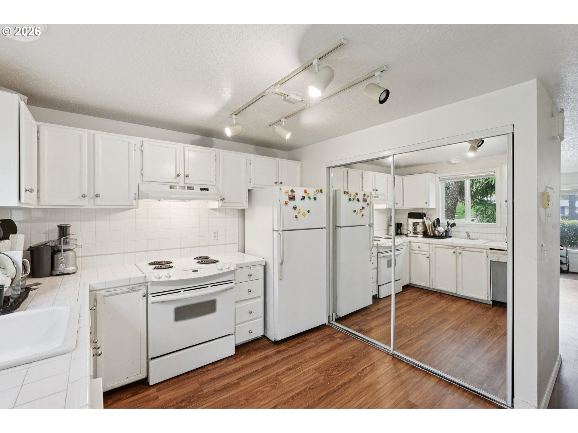 29480 Southwest Volley Street Wilsonville, OR 97070 - Photo 14 of 29 a kitchen with white cabinets and white appliances