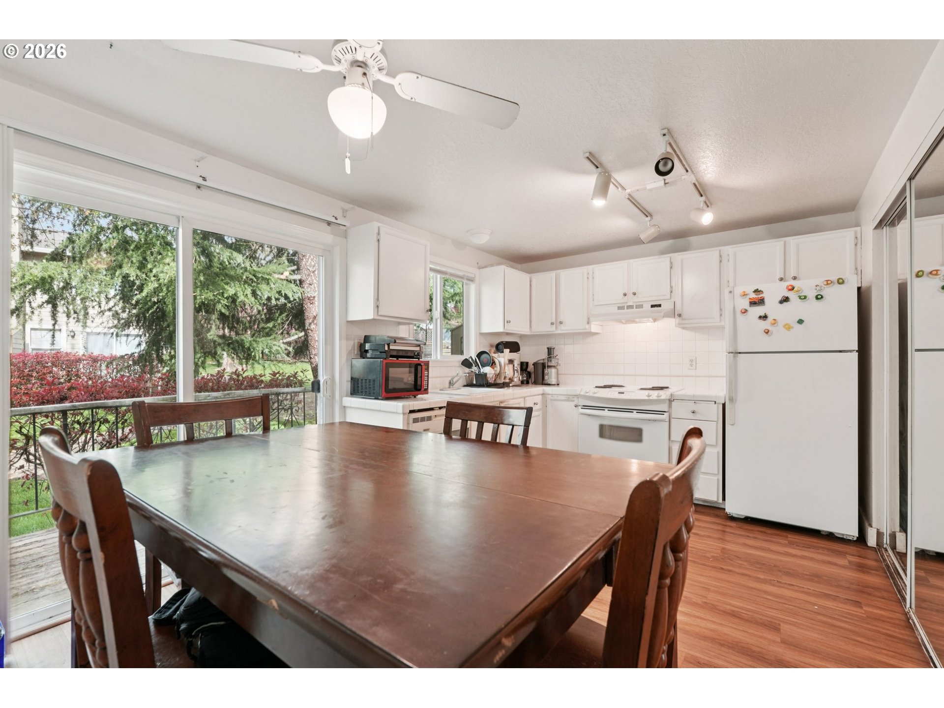29480 Southwest Volley Street Wilsonville, OR 97070 - Photo 10 of 29 a kitchen with white cabinets and stainless steel appliances
