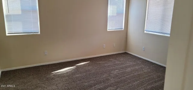 a bedroom with a bed and a tv on the dresser