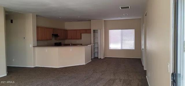 a kitchen with a sink a refrigerator and window