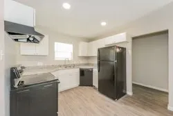 a kitchen with a refrigerator sink and microwave
