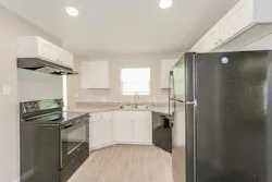 a kitchen with a sink and refrigerator
