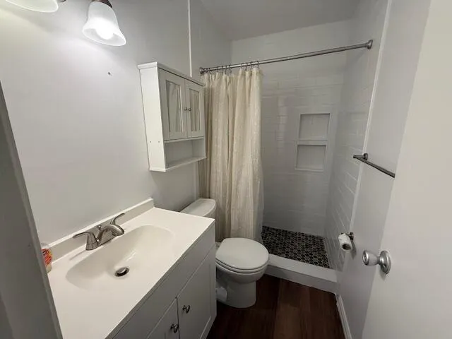 a bathroom with a sink toilet and shower