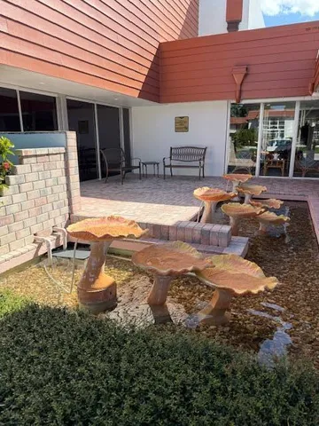 a view of a house with backyard and sitting area