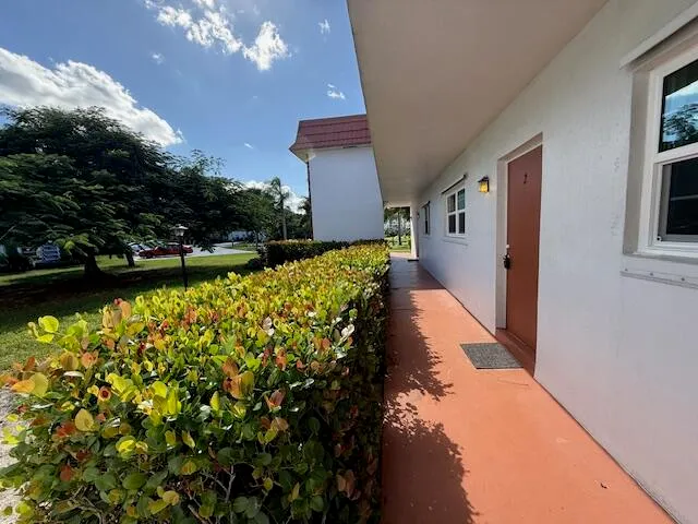 a view of a house with a yard and fountain in middle of the house