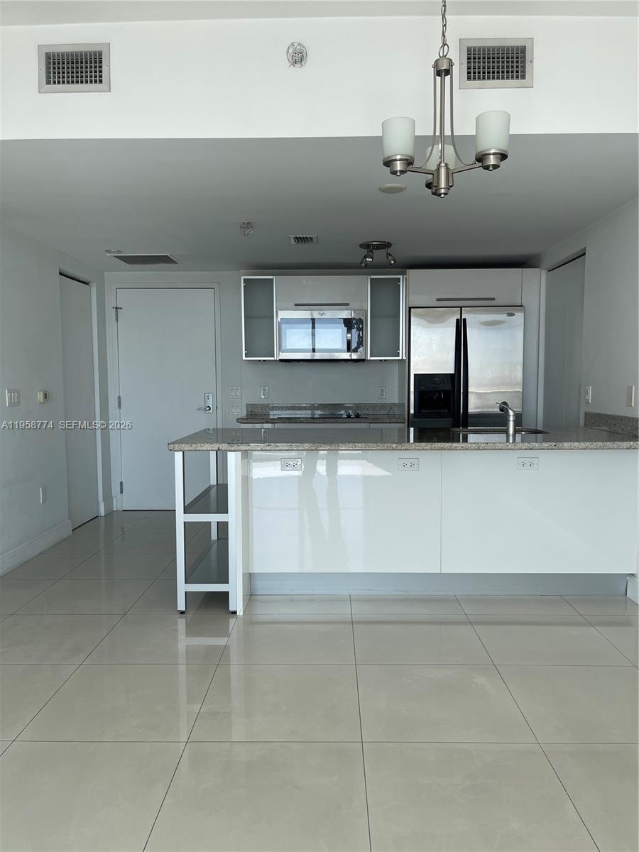 185 Southwest 7th Street, Unit 3810 Miami, FL 33130 - Photo 15 of 29 a view of a kitchen with a sink and cabinets