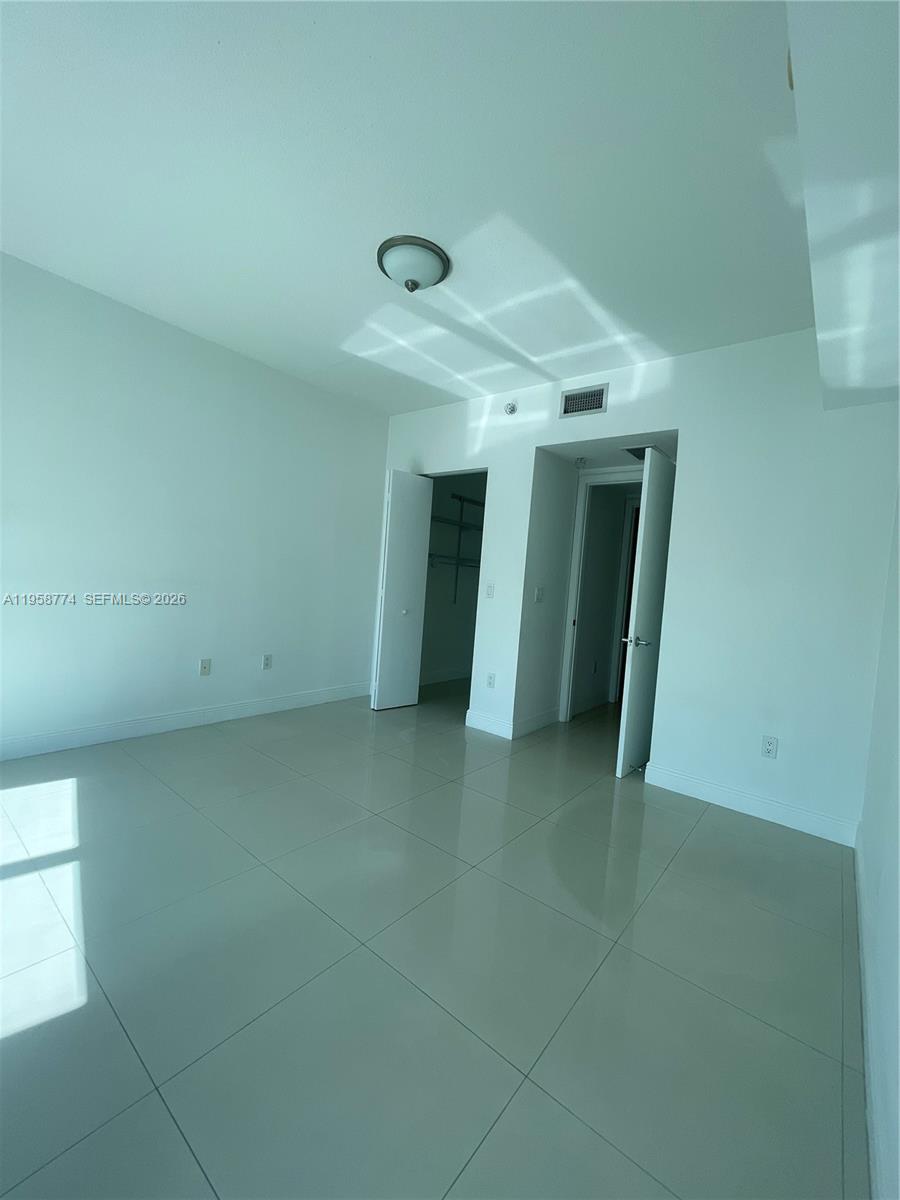 185 Southwest 7th Street, Unit 3810 Miami, FL 33130 - Photo 24 of 29 an empty room with closet and windows