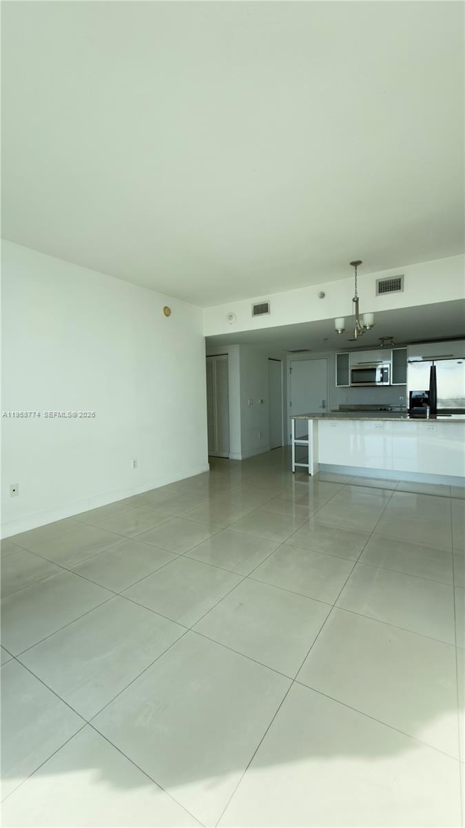 185 Southwest 7th Street, Unit 3810 Miami, FL 33130 - Photo 7 of 29 a view of a kitchen with furniture and cabinets