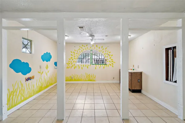 a view of a hallway to a livingroom with furniture