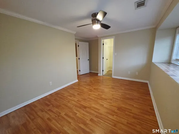 a view of an empty room and wooden floor