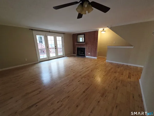 wooden floor in an empty room with a window