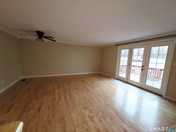 wooden floor in an empty room with a window