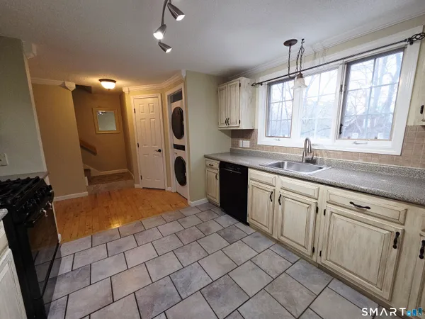 a kitchen with a sink window and cabinets
