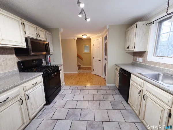a kitchen with a sink a stove and cabinets